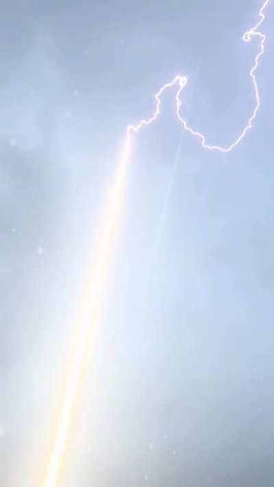 Lightning bolt is guided to ground through rocket trail.