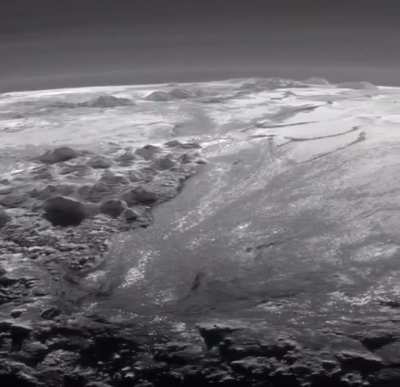 A wide shot of Pluto&rsquo;s Mountains and Frozen Plains from the New Horizons Space Probe