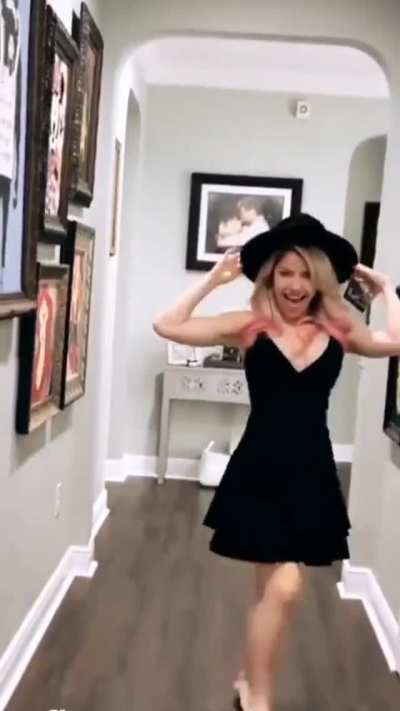 Alexa barefoot in a black dress