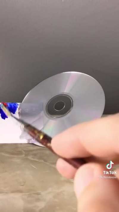 Guy matches the color of a cd with only paint