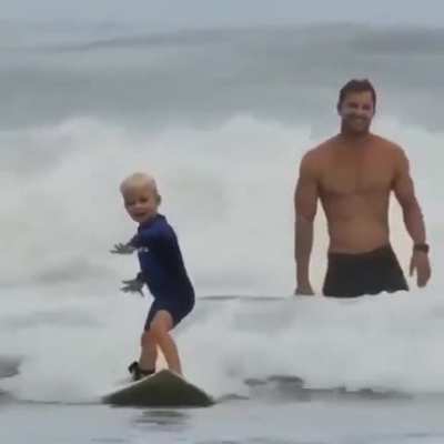 Fathers joy of his little surfer boy.