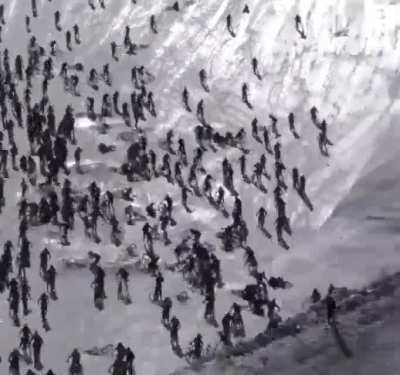Hundreds of riders hurtle down an icy cliff and crash into one another as "Mountain of Hell" downhill bike race lives up to its name.