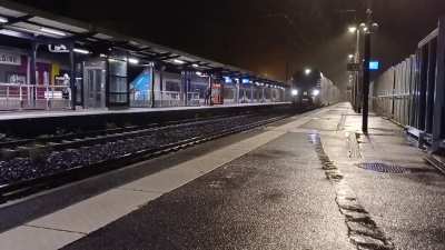 A French TER R&eacute;gio 2N arriving in the gloomy monday morning rain