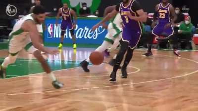Celtics star Jayson Tatum saves a ball from going out of bounds by flipping the ball behind-the-back to a wide-open teammate for a dunk