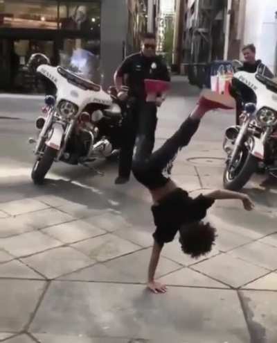 This kid wants to battle with a Police Officer on the floor!