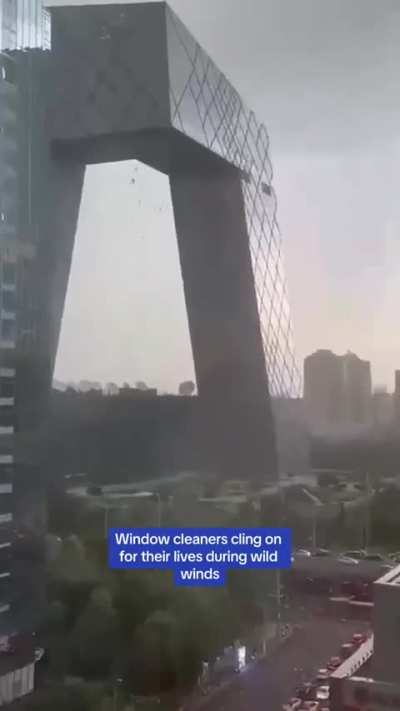 Window cleaners dangle from Beijing&rsquo;s tallest building during intense winds 