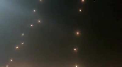 A barrage of dozens of rockets being intercepted by Iron Dome.