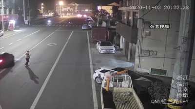 Darwin Contender Stands in the middle of the road on his phone oblivious of the passing cars...