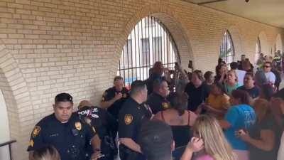 Parents clashed with San Antonio officers during Jefferson High School lock-down, after false reports of shooting [man injured arm trying to break window to get his kids].