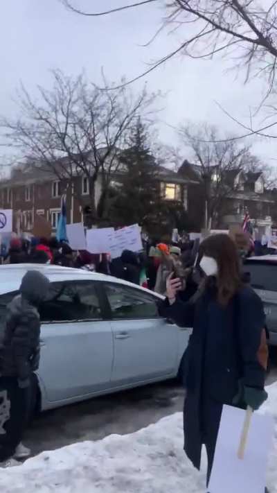 People marching at the site where Renee Good was murdered