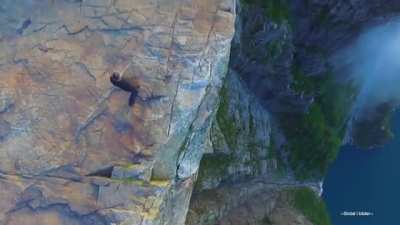 sitting on the edge of this cliff in Norway
