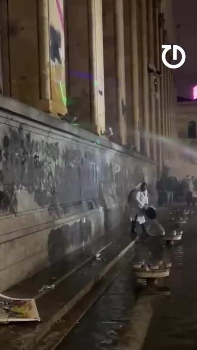 Protester in Georgia hurls buckets of water at riot police
