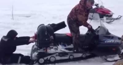 This guy tried to stand behind the Snowmobile