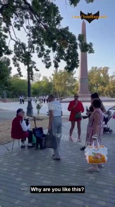 Woman tries to stop a street singer from singing in Russian in Odessa, Ukraine