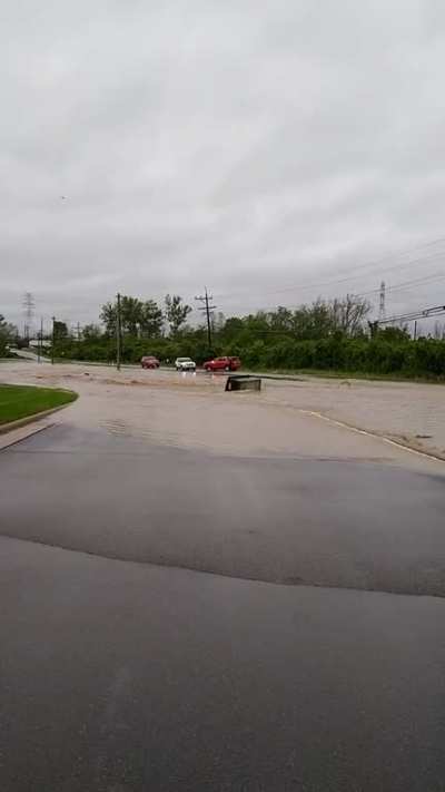 Dumpster floating down Windisch Rd in West Chester