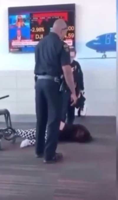 Woman being arrested fakes falling out of transport chair to avoid arrest
