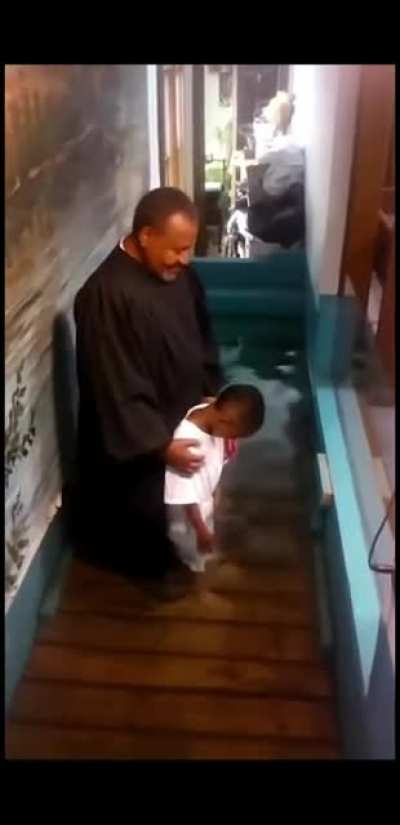 Little kid baptises himself because he was too excited.