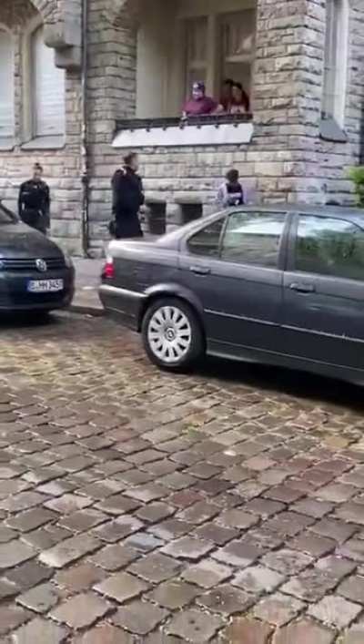German police having a tussle with a suspect.