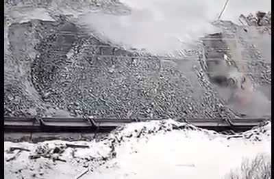 Mega-truck tips backwards and falls down stone cliff