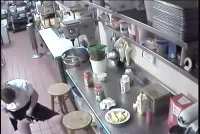 Female waitress puts a hot dog in her...