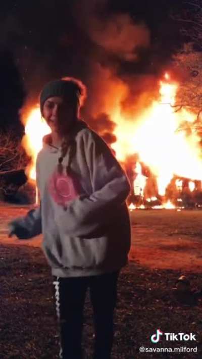 Trying to use a burning house for clout on TikTok. Her bio is “just trying to be famousssss”