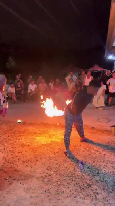 Guy performs a "rear end" fire show and regrets it.
