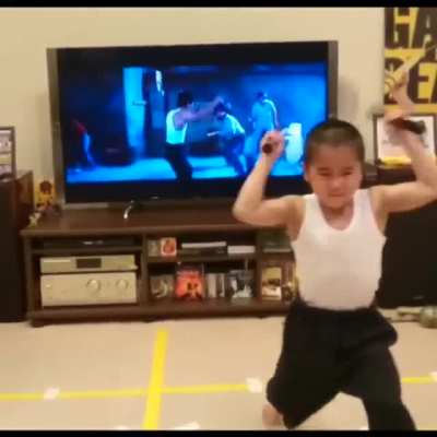 Kid imitates Bruce Lee karate scene