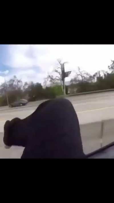 Dude in car won't stop drivin with man on back (source unknown)