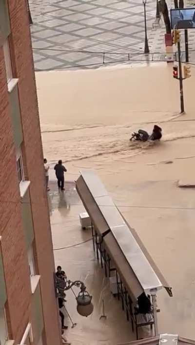 Mom of the year tries to cross floodwaters with a stroller
