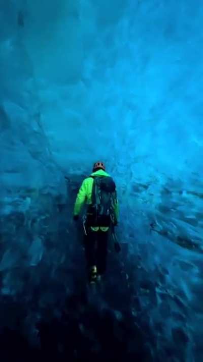 Walking though a blue ice crevasse in Iceland