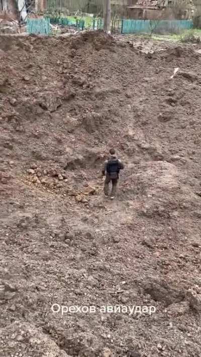 ua pov: Impact crater after Russian aviation bomb in Orechovo, Zaporozhie