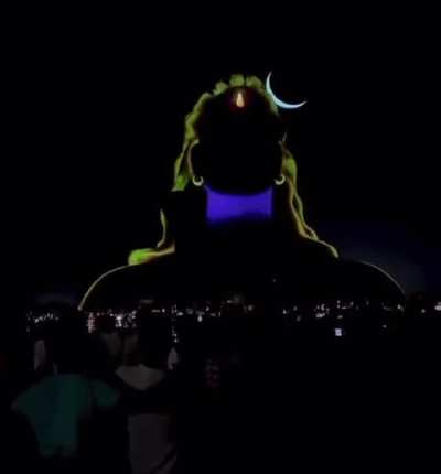 Giant statue of Shiva, known as the Adiyogi, aka &lsquo;the first yogi&rsquo;, lighting up. Lightning in the background coincidentally reveals the scale of the statue.