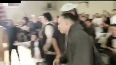 Wrestler spits gum on a kid