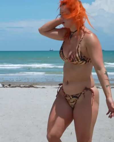 Showing off her ass and tits at the beach