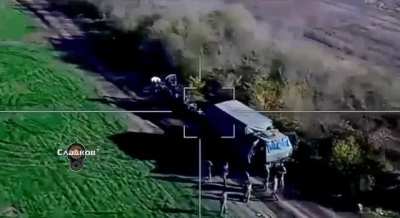 Russian Lancet drone hitting parked Ukrainian M777 howitzer next a group of Ukrainian soldiers. 2022