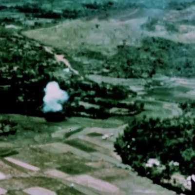 View from a UH-1 helicopter of an A-4 Skyhawk dropping ordnance n a target marked by white phosphorous in South Vietnam in October 1966