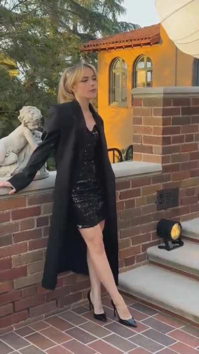 Kiernan Shipka in a photo shoot with a black mini dress.