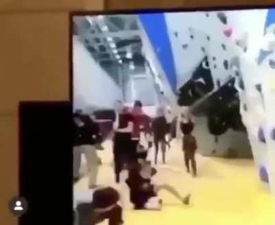 Kid falls off a Climbing Wall then shrugs it off