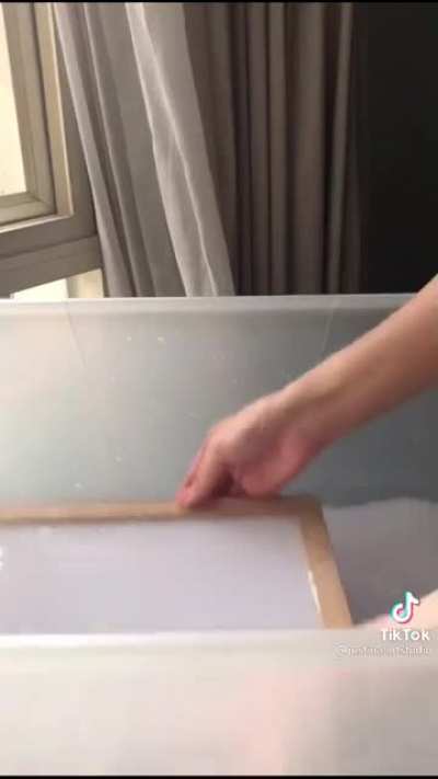 Recycling unused paper into a new handmade paper at home.
