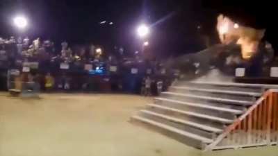 Man taunts a bull who has flaming horns