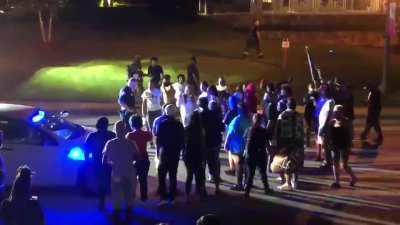 After arsonists start multiple fires in South Caroline last night a single lone police officer tries to offer protection for firefighters to put them out. Protesters throw a rock at him