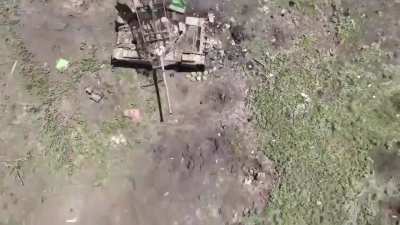 A Ukrainian drone operator drops a grenade on some anti-tank mines close to a disabled Russian tank. 