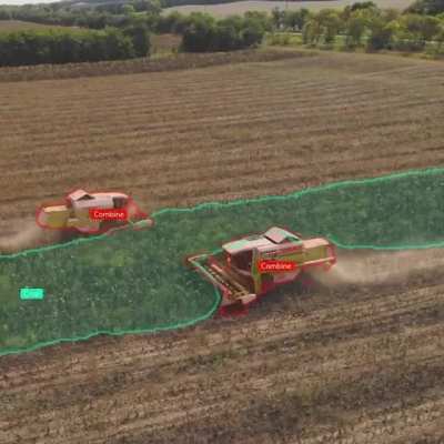 Combines munching through crops as seen by a drone&rsquo;s machine vision