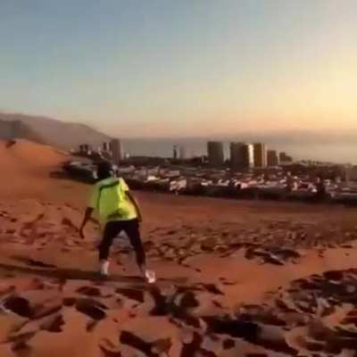 Sandboarding in a self made downhill parkour