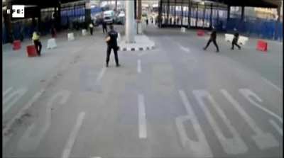 He injures a policeman while shouting "Allah is great" at the Spain/Morocco border, the police throw a fence at him.