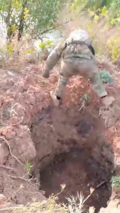 Cruel soldiers take picture with turtle, then carefully place it in to deep hole...
