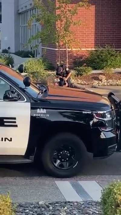 Cop points his gun at a young man who surrendered, and then tries to break his arm.