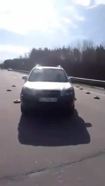 Ukrainians drive between Russian landmines