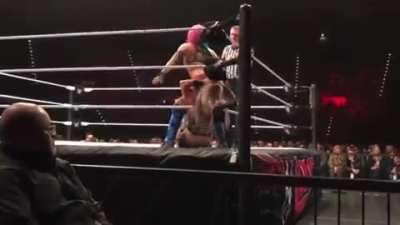 Asuka With a Stinkface to Dana Brooke.