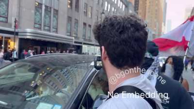 Protesters in NYC spit on a car